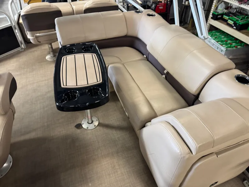 Slide: The Image of 2019 Sun Tracker SportFish 22 XP3 interior with beige seating and a central table. - 6