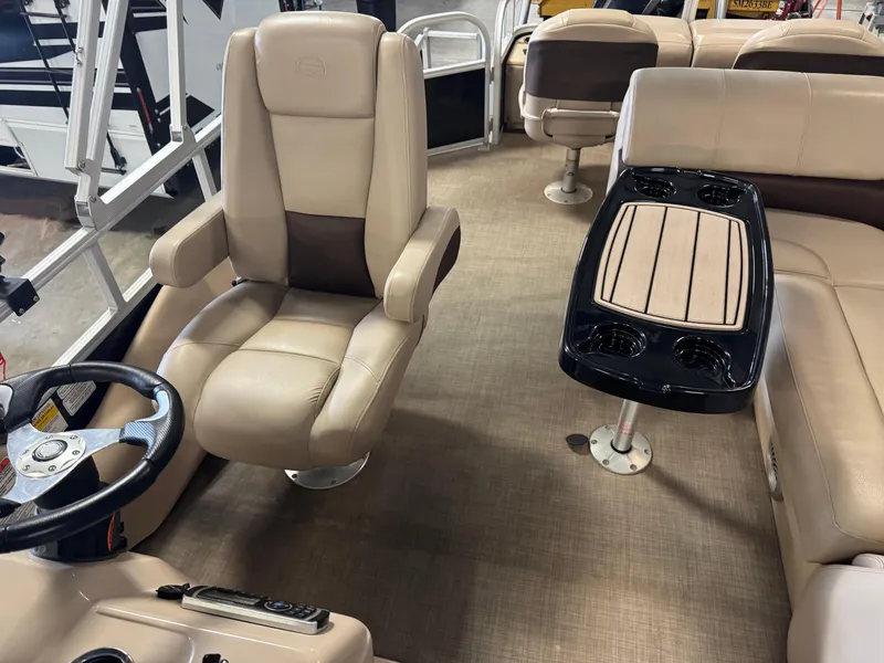 Slide: The Image of 2019 Sun Tracker SportFish 22 XP3 interior with beige seating and steering wheel. - 7