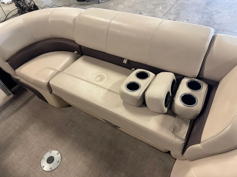 Slide: The Image of 2019 Sun Tracker SportFish 22 XP3 boat interior with beige seating and cup holders. - 8