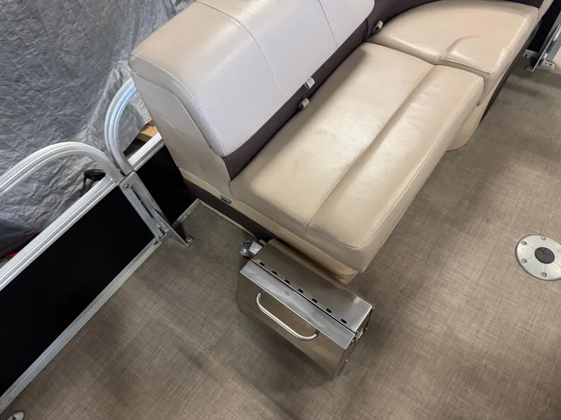 Slide: The Image of 2019 Sun Tracker SportFish 22 XP3 boat interior with beige seating and metal railing. - 9