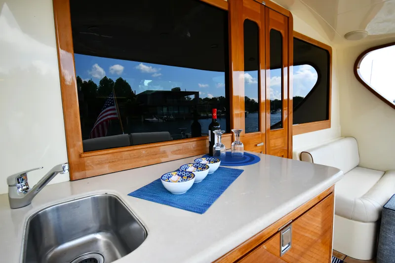 Slide: The Image of Luxurious interior of 2020 Palm Beach Motor Yachts PB52 with elegant dining setup. - 13