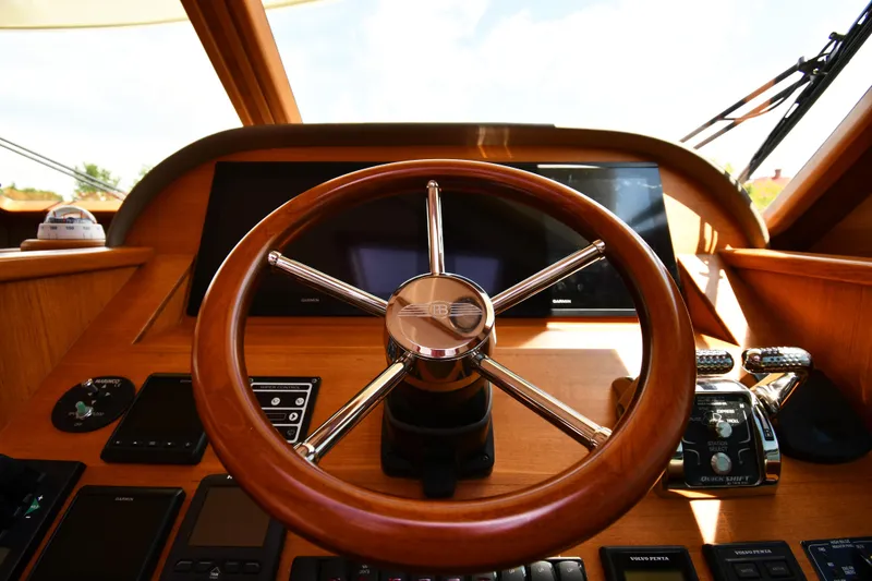 Slide: The Image of Steering wheel of 2020 Palm Beach Motor Yachts PB52, featuring modern controls and navigation equipment. - 35