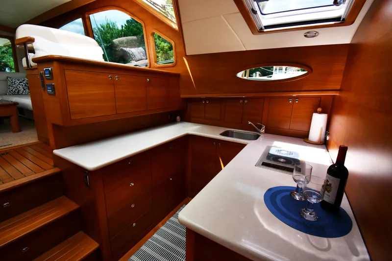 Slide: The Image of Luxurious 2020 Palm Beach Motor Yachts PB52 interior with elegant wood cabinetry and modern amenities. - 38
