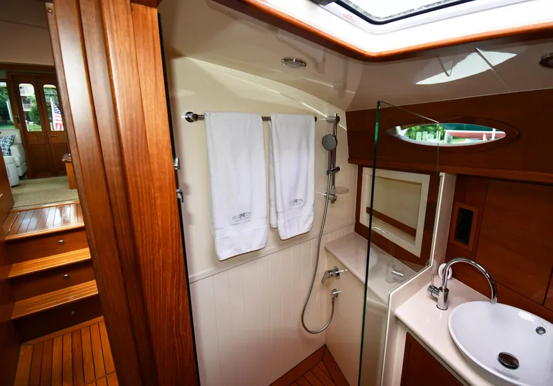 Slide: The Image of Luxurious bathroom interior of 2020 Palm Beach Motor Yachts PB52, featuring wood accents and modern fixtures. - 45