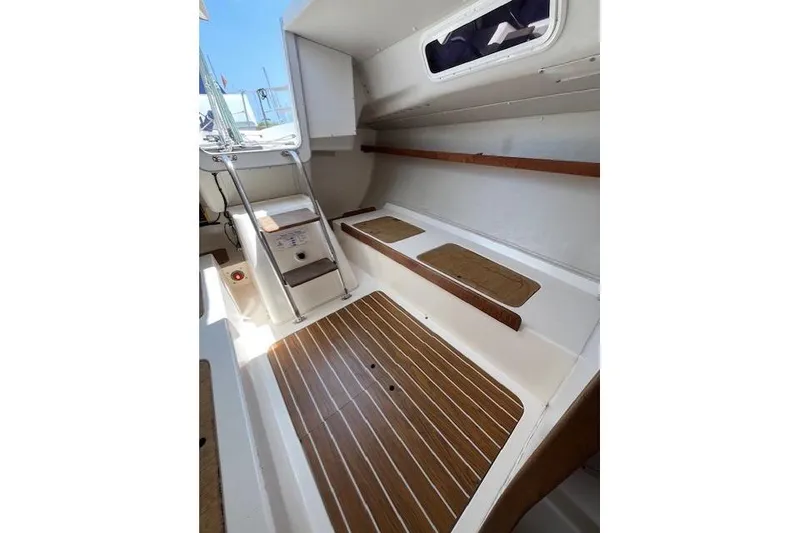 Slide: The Image of 2005 J Boats J/100 interior with wooden flooring and seating area. - 16