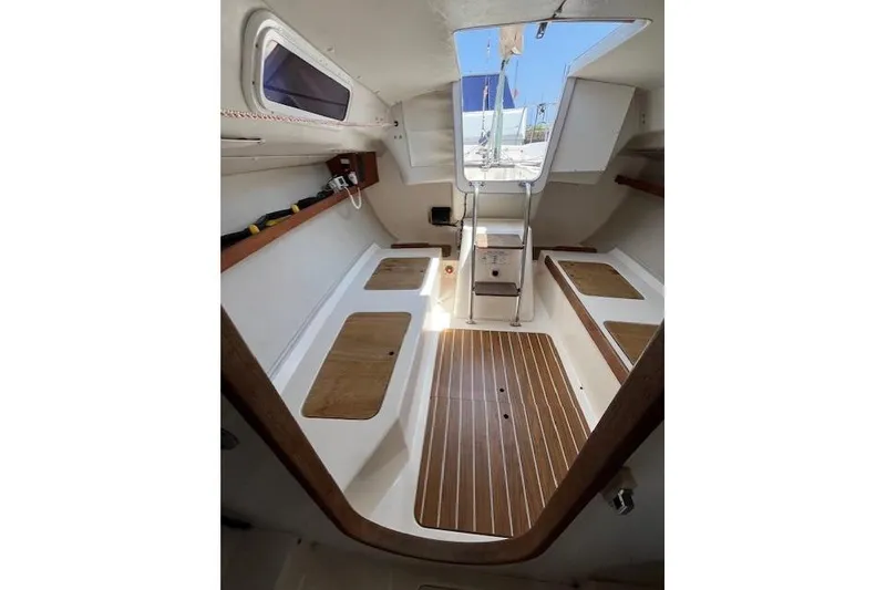 Slide: The Image of Interior of 2005 J Boats J/100 sailboat, featuring wooden flooring and seating. - 17