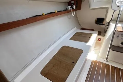 Slide: The Image of Interior of 2005 J Boats J/100 sailboat with wooden accents and storage compartments. - 19