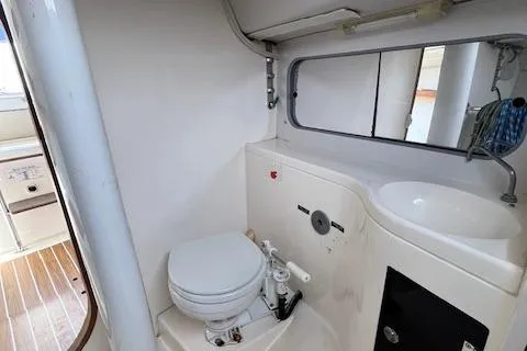 Slide: The Image of 2005 J Boats J/100 yacht bathroom with toilet, sink, and mirror. - 24