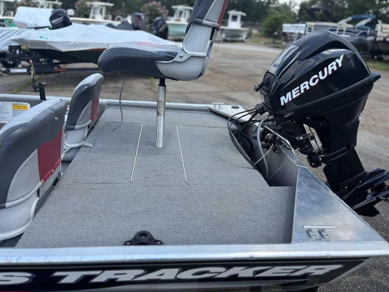 Slide: The Image of 2013 Tracker Pro 160 boat with Mercury outboard motor, featuring seating and deck. - 11