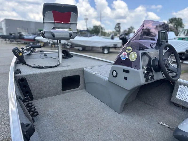 Slide: The Image of 2013 Tracker Pro 160 boat interior with steering console and fishing seat. - 13