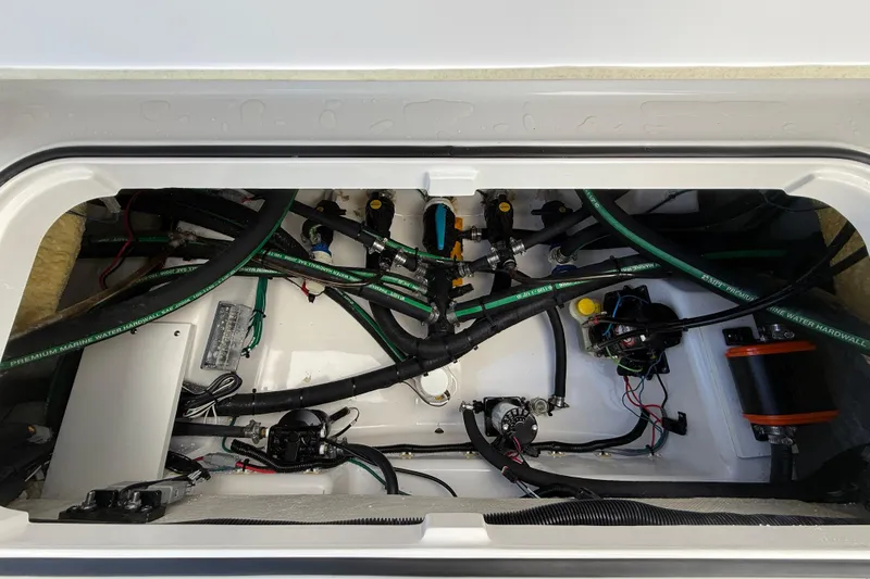 Slide: The Image of 2024 Caymas 28 HB boat interior showing complex wiring and plumbing system. - 17