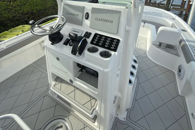 Slide: The Image of 2024 Caymas 28 HB boat cockpit with Garmin displays and modern controls. - 20