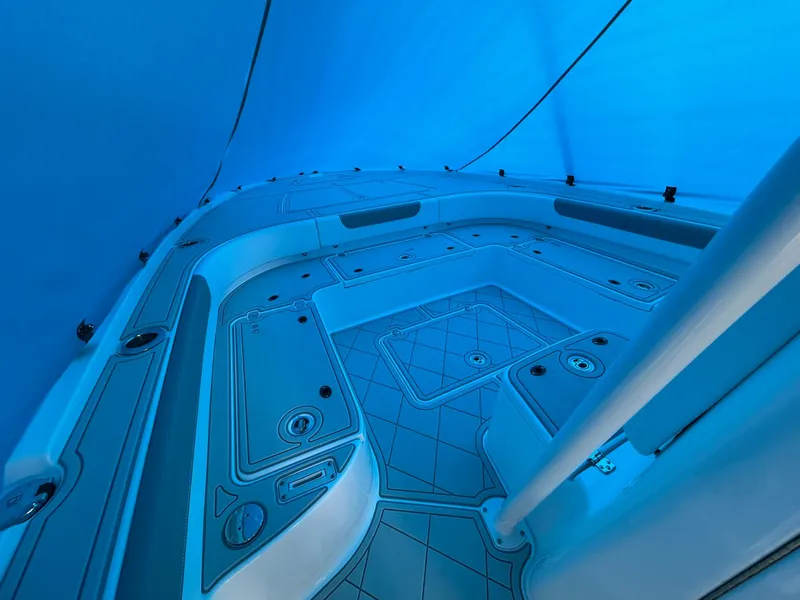 Slide: The Image of 2024 Caymas 28 HB boat interior with sleek, modern design under blue lighting. - 6