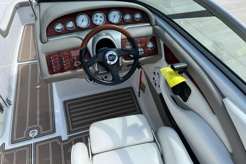Slide: The Image of 2006 Cobalt 240 boat dashboard with gauges, steering wheel, and control panel. - 11