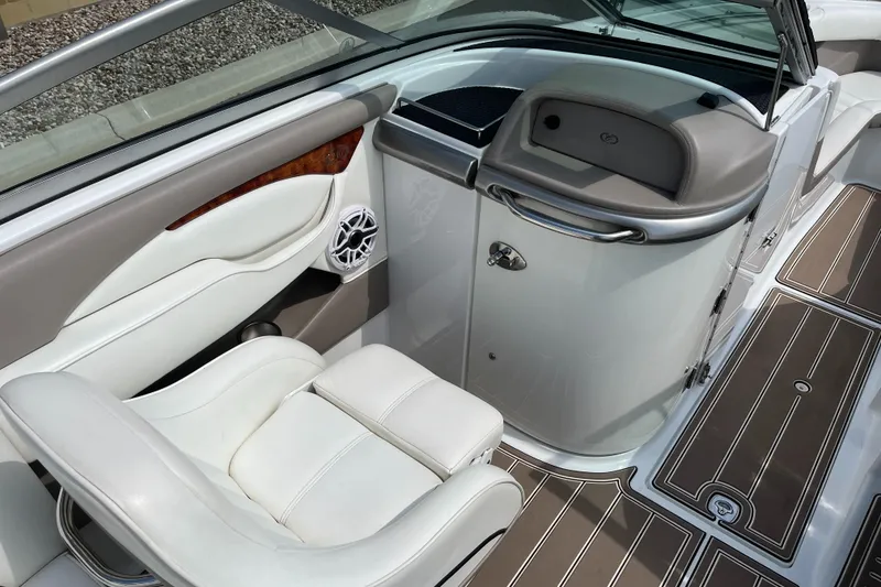 Slide: The Image of 2006 Cobalt 240 boat interior with white seating and wood-accented details. - 12