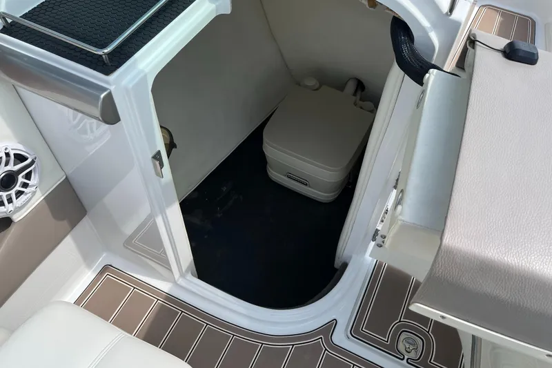 Slide: The Image of 2006 Cobalt 240 boat interior with storage compartment and speaker. - 13