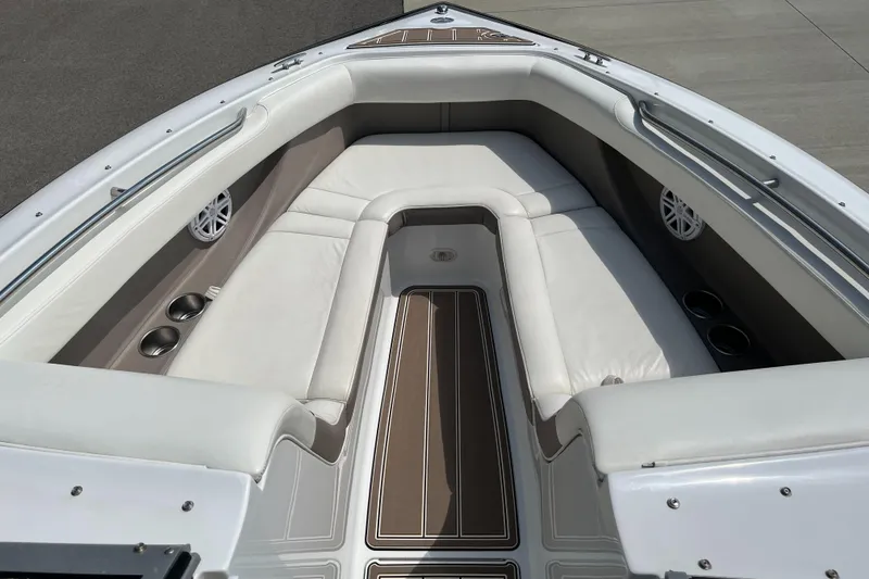 Slide: The Image of 2006 Cobalt 240 boat interior with white seating and cup holders. - 14