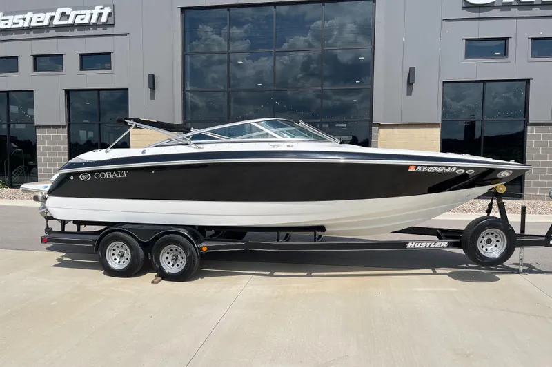 Slide: The Image of 2006 Cobalt 240 boat on trailer, parked outside MasterCraft building. - 3