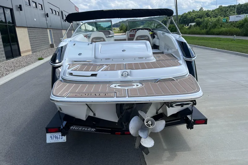 Slide: The Image of 2006 Cobalt 240 boat on trailer, rear view, parked outdoors near building. - 8