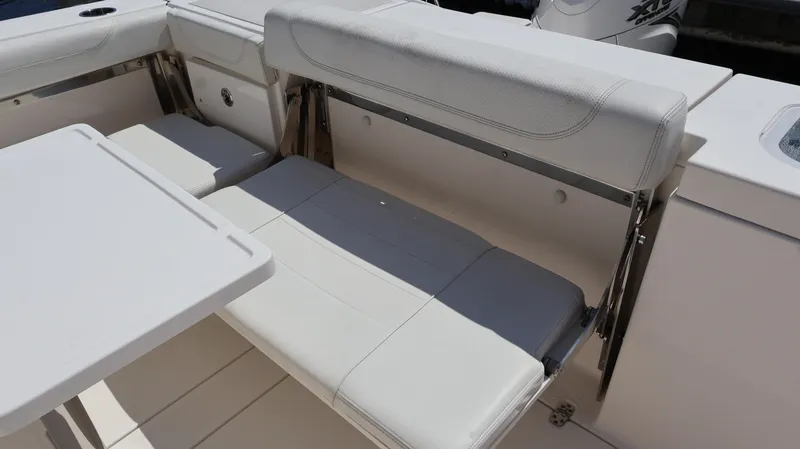 Slide: The Image of 2023 Pursuit OS 355 Offshore boat interior with white seating and table. - 14