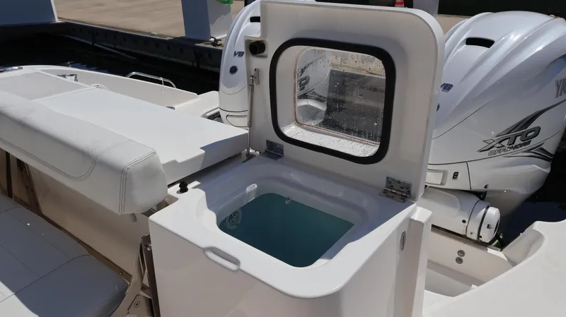 Slide: The Image of 2023 Pursuit OS 355 Offshore boat with open storage compartment and powerful engines. - 18