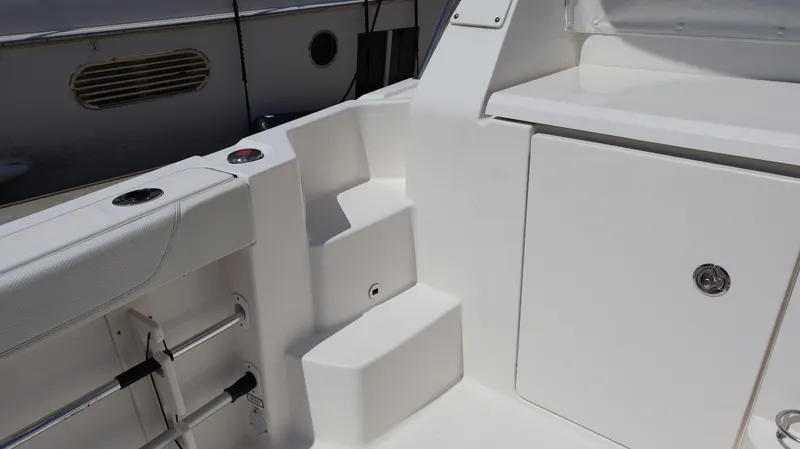 Slide: The Image of 2023 Pursuit OS 355 Offshore boat interior with seating and storage compartment. - 19