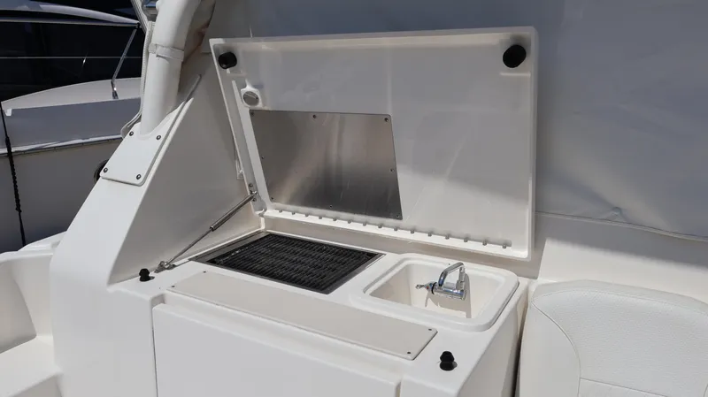 Slide: The Image of 2023 Pursuit OS 355 Offshore boat kitchenette with sink and grill. - 22