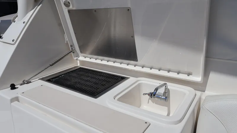 Slide: The Image of 2023 Pursuit OS 355 Offshore boat sink and grill area. - 24
