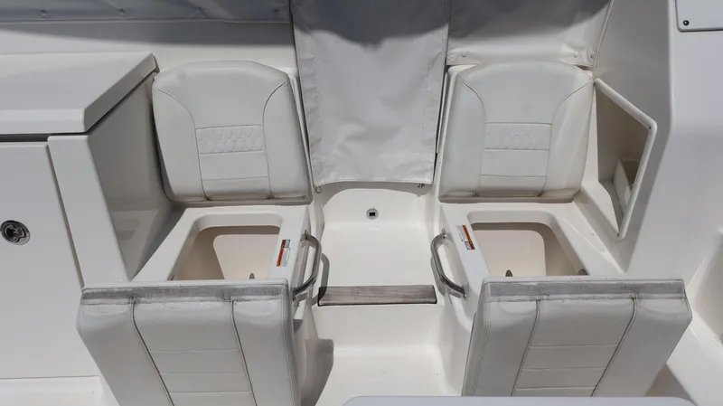 Slide: The Image of 2023 Pursuit OS 355 Offshore boat seating area with storage compartments. - 26