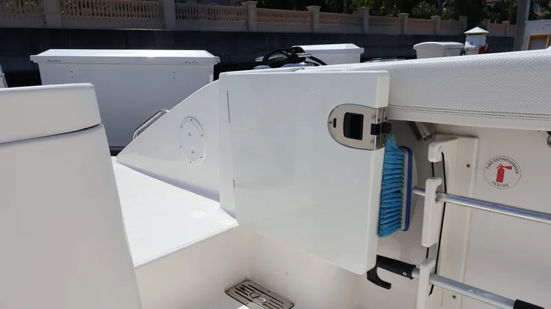 Slide: The Image of 2023 Pursuit OS 355 Offshore boat interior with storage compartment and fire extinguisher sign. - 27