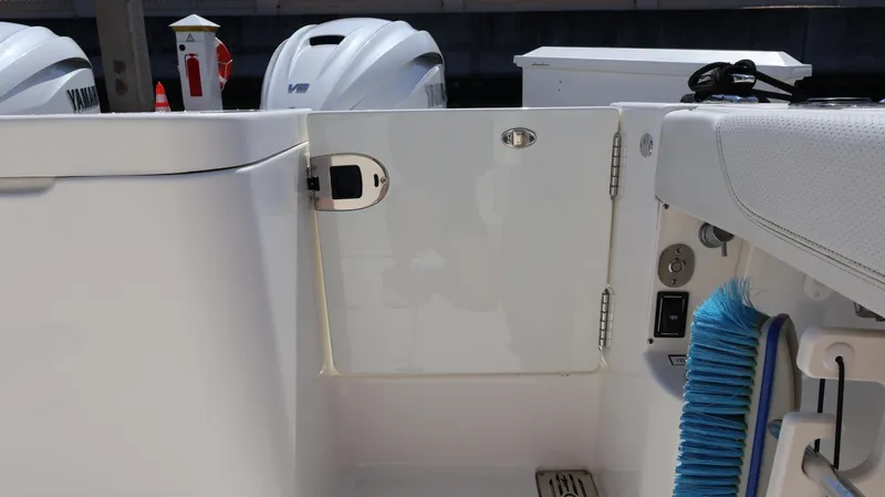 Slide: The Image of 2023 Pursuit OS 355 Offshore boat deck with Yamaha engines and cleaning brush. - 28