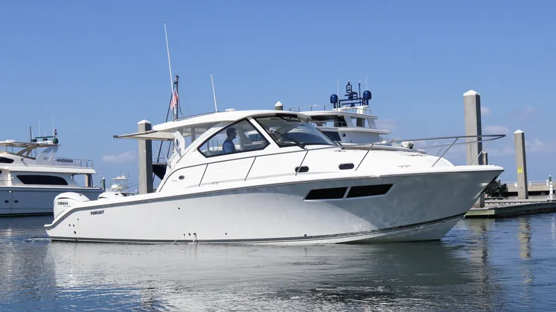 Slide: The Image of 2023 Pursuit OS 355 Offshore boat docked in marina under clear blue sky. - 3