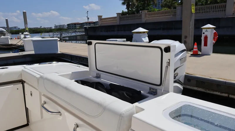 Slide: The Image of 2023 Pursuit OS 355 Offshore boat at dock, featuring open storage compartment. - 32