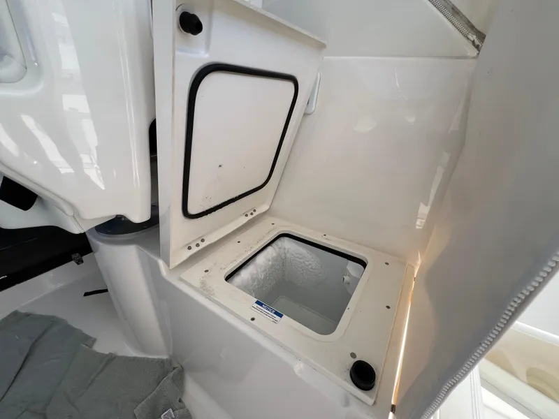Slide: The Image of 2023 Pursuit OS 355 Offshore boat storage compartment with open hatch. - 37