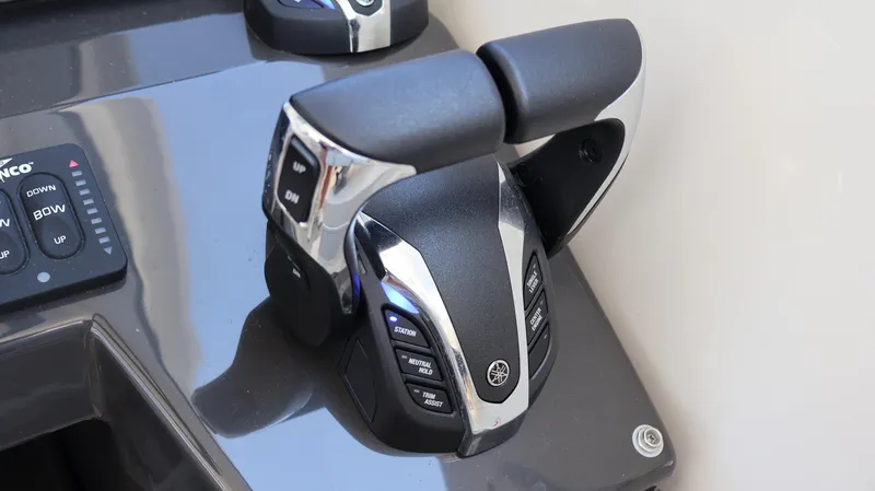 Slide: The Image of Throttle controls on 2023 Pursuit OS 355 Offshore boat dashboard. - 42