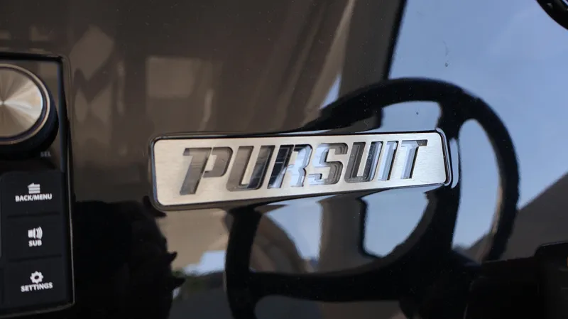 Slide: The Image of 2023 Pursuit OS 355 Offshore dashboard with logo and control panel. - 43