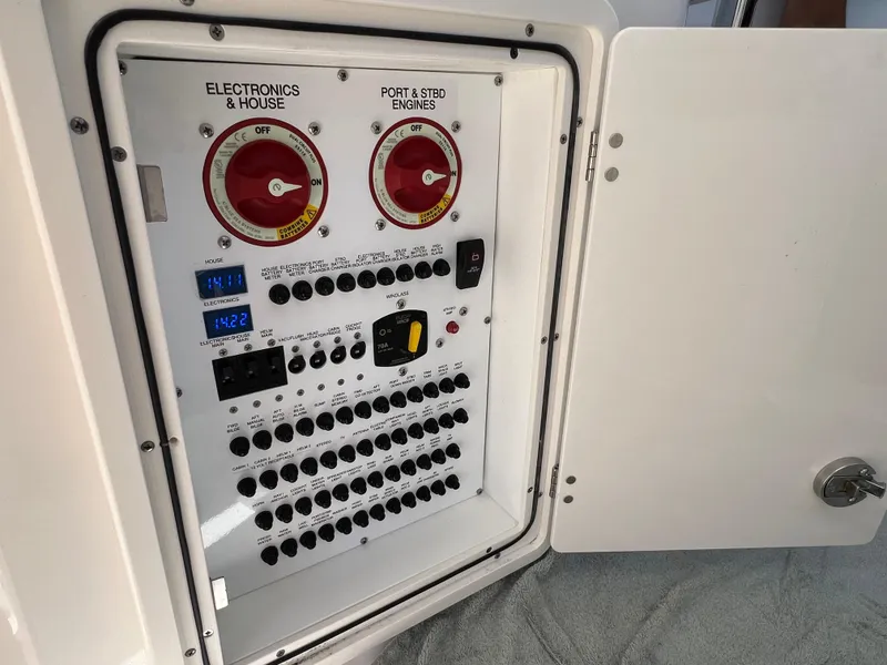 Slide: The Image of Control panel of 2023 Pursuit OS 355 Offshore boat, featuring electronics and engine switches. - 47