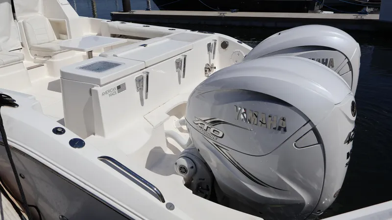 Slide: The Image of 2023 Pursuit OS 355 Offshore boat with Yamaha engines, docked at marina. - 7