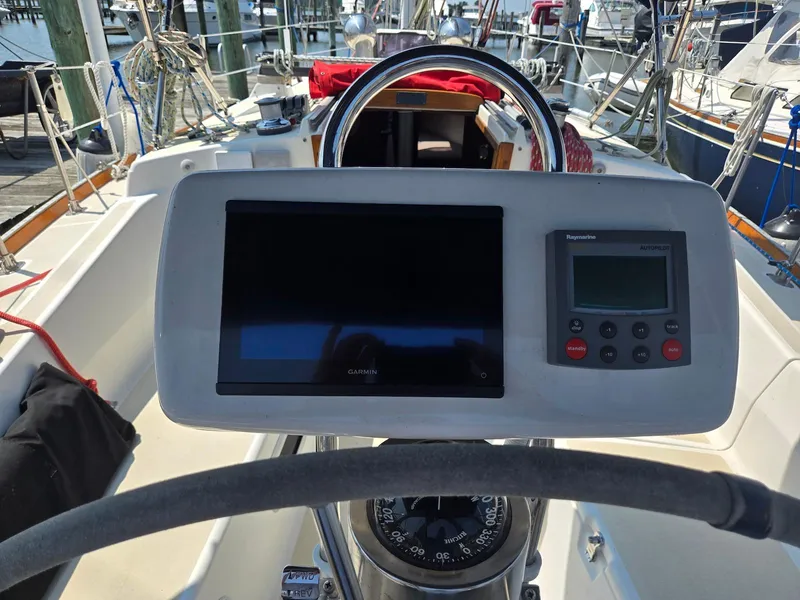 Slide: The Image of Cockpit of a 1994 Tartan 31 sailboat with navigation instruments and steering wheel. - 10