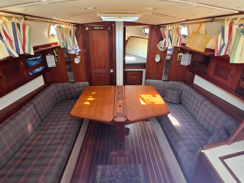 Slide: The Image of Interior of a 1994 Tartan 31 sailboat with wood finish and cozy seating area. - 14
