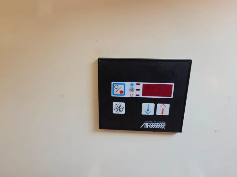 Slide: The Image of Control panel of a 1994 Tartan 31, featuring temperature and fan settings. - 22
