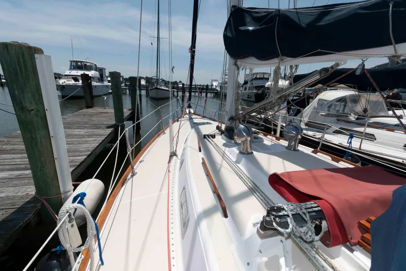 Slide: The Image of Sailboat docked at marina, Tartan 31 model, 1994, with clear sky and surrounding boats. - 8
