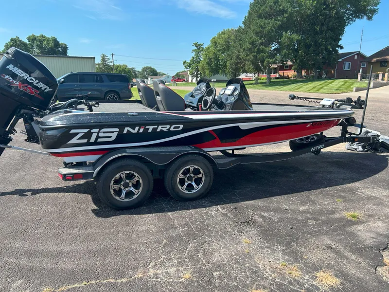 Slide: The Image of 2018 Nitro Z19 boat with Mercury Pro XS engine on trailer, parked outdoors. - 3