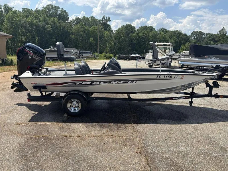 Slide: The Image of 2013 Tracker Pro Team™ 190 TX boat on trailer, parked outdoors under a cloudy sky. - 5