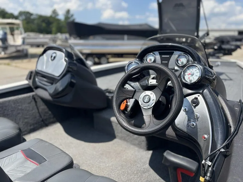 Slide: The Image of 2013 Tracker Pro Team™ 190 TX boat interior with steering wheel and dashboard controls. - 6