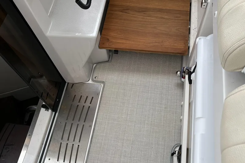 Slide: The Image of Interior view of 2022 Regal 33 SAV boat, featuring sleek flooring and wooden accents. - 17