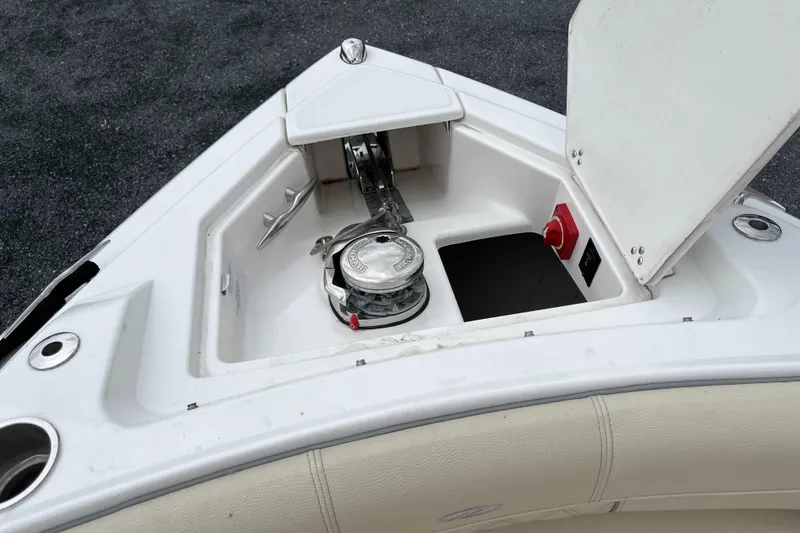Slide: The Image of Anchor compartment of 2022 Regal 33 SAV boat, featuring a winch and storage space. - 18
