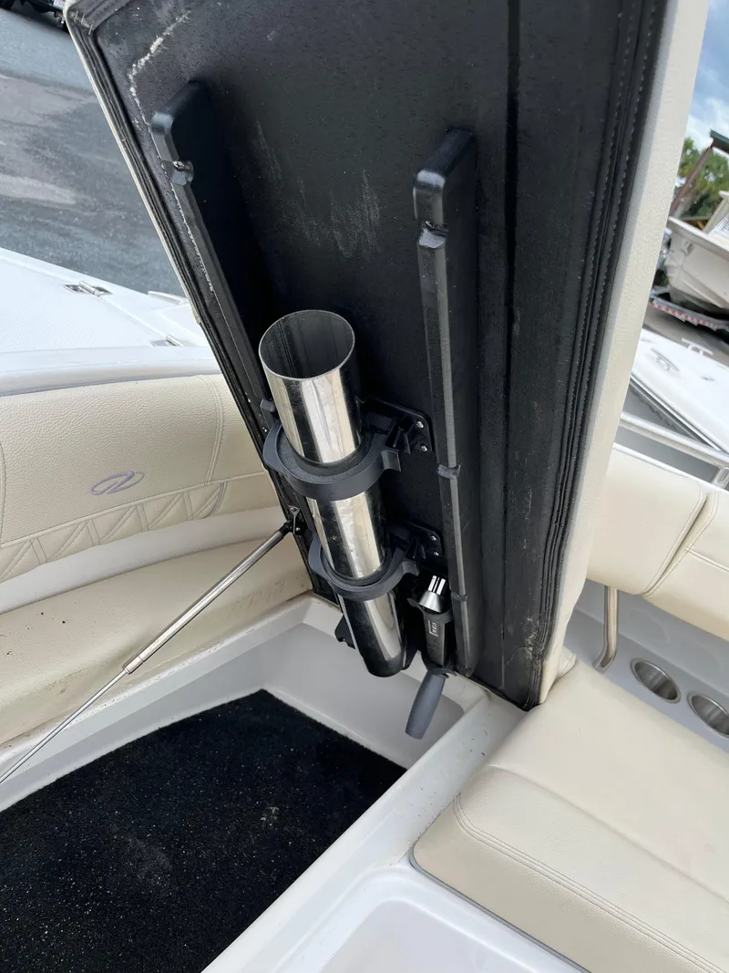 Slide: The Image of 2022 Regal 33 SAV boat interior with rod holder and beige seating. - 20