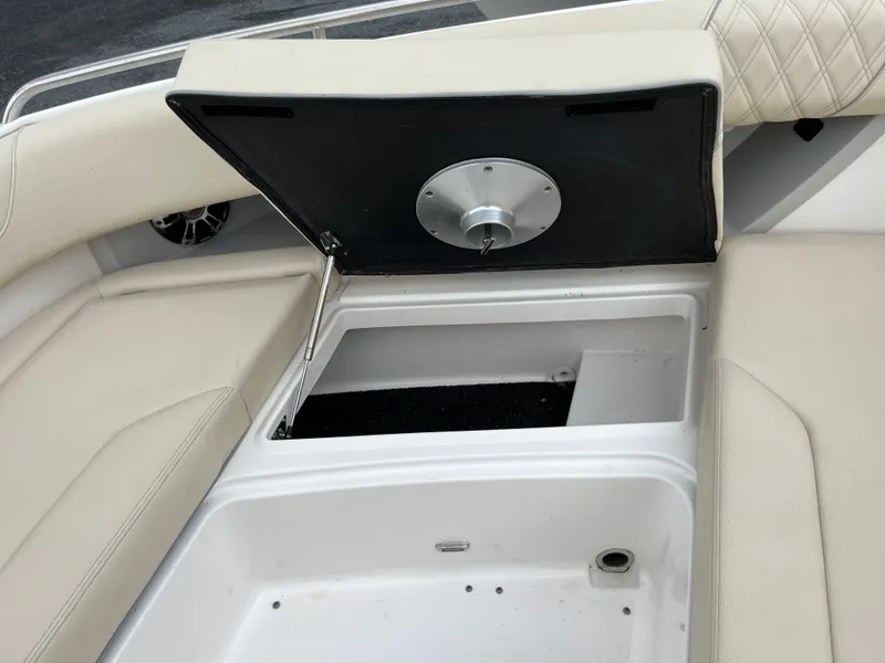 Slide: The Image of 2022 Regal 33 SAV boat storage compartment with open lid, showcasing spacious interior. - 24
