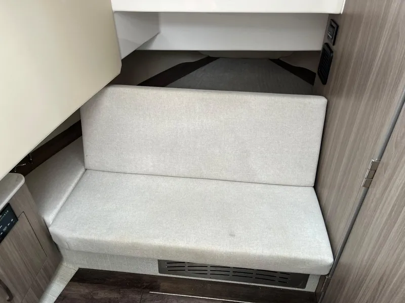 Slide: The Image of 2022 Regal 33 SAV interior with beige seating and modern wood accents. - 27